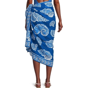 Detail of royal blue sarong beach wrap with white seashell print and patterned border