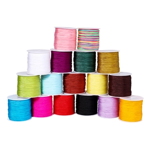 Close-up of 0.8mm colorful nylon cord spools stacked for DIY jewelry weaving and crafts