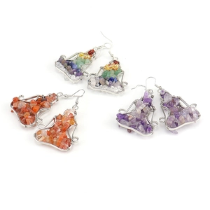 Handmade wire wrapped natural stone yoga pose earrings in multiple colors on white background
