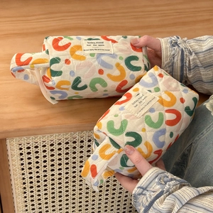 Quilted cotton travel toiletry bags with colorful abstract prints and soft texture