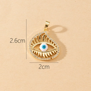 Detailed view of evil eye charm with blue center and rhinestones measuring 2.6cm x 2cm
