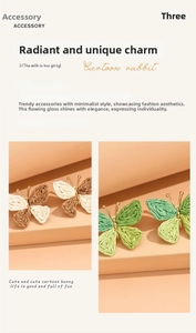 Close-up of handmade raffia butterfly earrings with colorful woven texture and gold frame