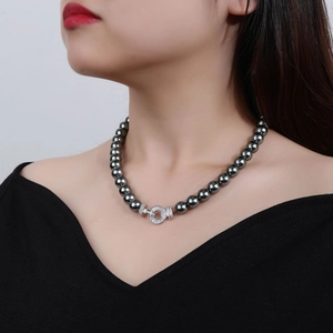 Elegant dark grey pearl necklace with micro-set diamond metal clasp on female model