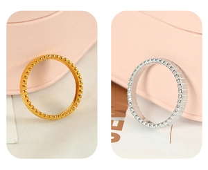 Detail of vintage titanium steel gear rings in gold and silver finish with studded texture