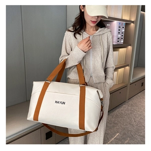 Detail of large-capacity yoga fitness bag with HAYUN logo and brown woven handles
