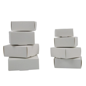 Stack of minimalist white kraft paper boxes in various sizes for jewelry packaging