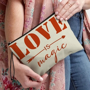 Portable canvas makeup bag with 'LOVE IS magic' print and black zipper strap