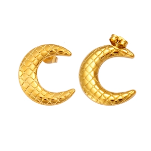 Detail of golden crescent moon earrings featuring a textured diamond quilted pattern