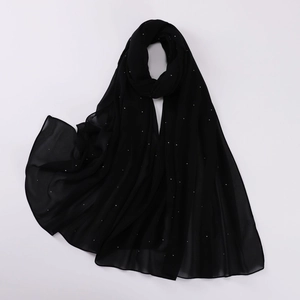 Detailed close-up of black pearl chiffon scarf with shimmering silver rhinestones