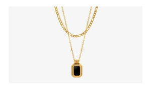 Detail view of double-layer necklace with black octagonal pendant and golden Figaro chain