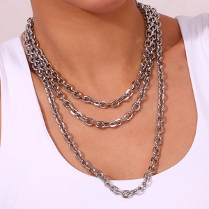 Detail of layered silver stainless steel chain necklace showing thick chunky metal links