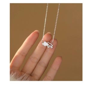 Close-up of S999 silver cloud pendant with white shell inlay and sparkling rhinestones