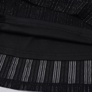 Macro shot of striped lurex fabric with mesh lining and vertical black gold metallic texture