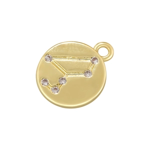 Detail of a vintage golden round zodiac pendant with micro-inlaid cubic zirconia crystals