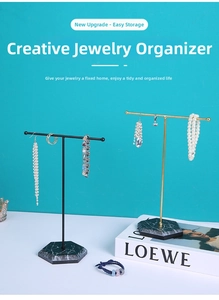 Detail of T-shaped jewelry stands with marble bases for necklaces and earrings