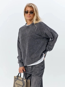 Detail of vintage washed charcoal grey cotton sweatshirt with drop shoulder design
