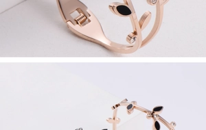 Detail of rose gold leaf bracelet with black enamel finish and sparkling zircons