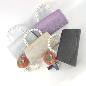 Sparkly glitter fabric evening clutches with pearl handles in multiple colors for formal events
