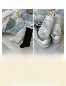 Close-up of ballet style ribbed cotton socks with ribbons and floral bow accents