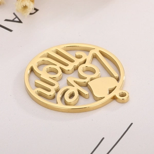 Detailed view of a gold circular Love Mom pendant with heart cutout on white background