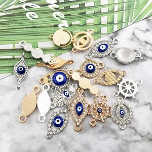 Detail view of evil eye and ship wheel charms for DIY jewelry making with cubic zirconia