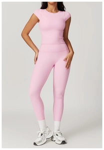 Detailed view of pink two-piece yoga set with slim fit short sleeve top and high waist leggings
