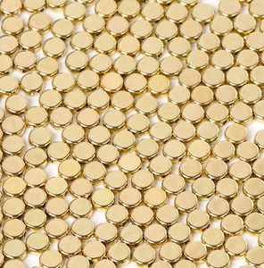 Close-up of golden CCB flat round beads with side holes for DIY jewelry making