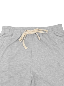 Detail of the elastic waistband and woven drawstring on gray summer casual shorts