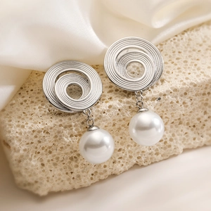 Minimalist vintage 18K gold geometric earrings with pearls on a natural stone base