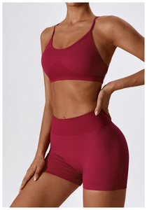 Detail of high-stretch seamless dark pink sports bra and high-waist yoga shorts set