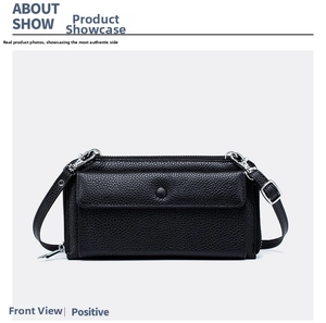 Close-up of black lychee-patterned leather phone bag with buckle and silver zipper