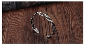 Detail of Thai silver open cuff featuring hand-hammered texture and braided wire design