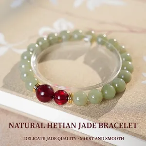 Natural Hetian Jade bead bracelet with red agate and gold spacers on elegant floral book