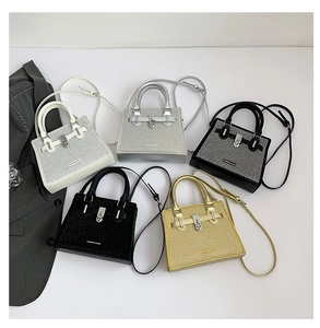 Flat lay of rhinestone handbag collection in white, silver, black, and gold colors