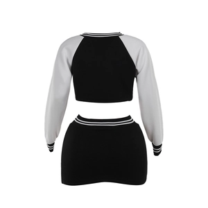 Rear view of slim fit black and white two-piece baseball sweatshirt and mini skirt set