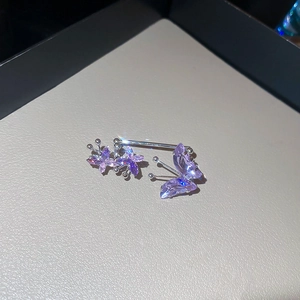 Detailed close-up of butterfly ear cuff with sparkling purple zircons and silver finish