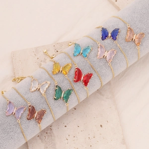 Detailed view of ten colorful butterfly charms on adjustable 18K gold-plated chains