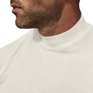 Close-up of men's turtleneck base layer showing ivory knit texture and neckline detail