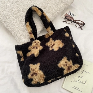 Detail shot of plush teddy bear tote bag with soft lamb wool texture on white fabric