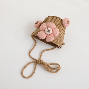 Detail of children straw crossbody bag with pink floral accent and secure zipper closure