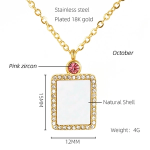 Detail showing 18K gold plated necklace with natural shell and pink zircon accents