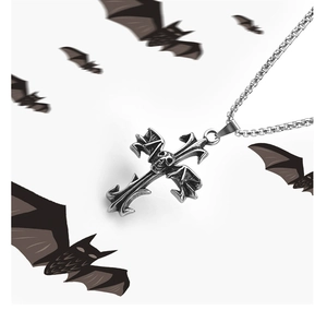 Detailed view of a silver bat-winged skull cross necklace with gothic styling elements