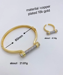 Detail of 18k gold plated horseshoe bangle and open ring set with white cubic zirconia