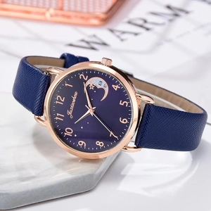 Detail of rose gold quartz watch with starry sky dial on marble surface