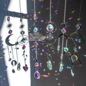 Rainbow crystal prisms in lotus moon sun shapes reflecting colorful light on dark background