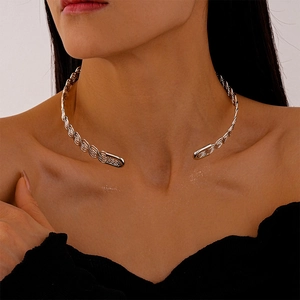 Detailed macro view of silver twisted metal choker necklace showing texture and finish