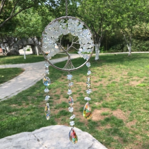 Detail of tree of life suncatcher with white crystals and faceted drop pendants