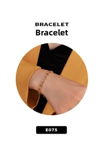 Close-up of a minimalist gold coffee bean link bracelet worn on a woman wrist