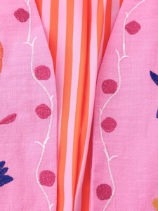 Close-up of pink linen cardigan with embroidery and orange striped lining details