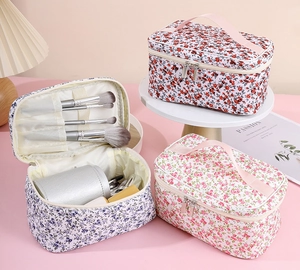 Detailed interior of floral makeup bags showing brush slots and spacious compartments